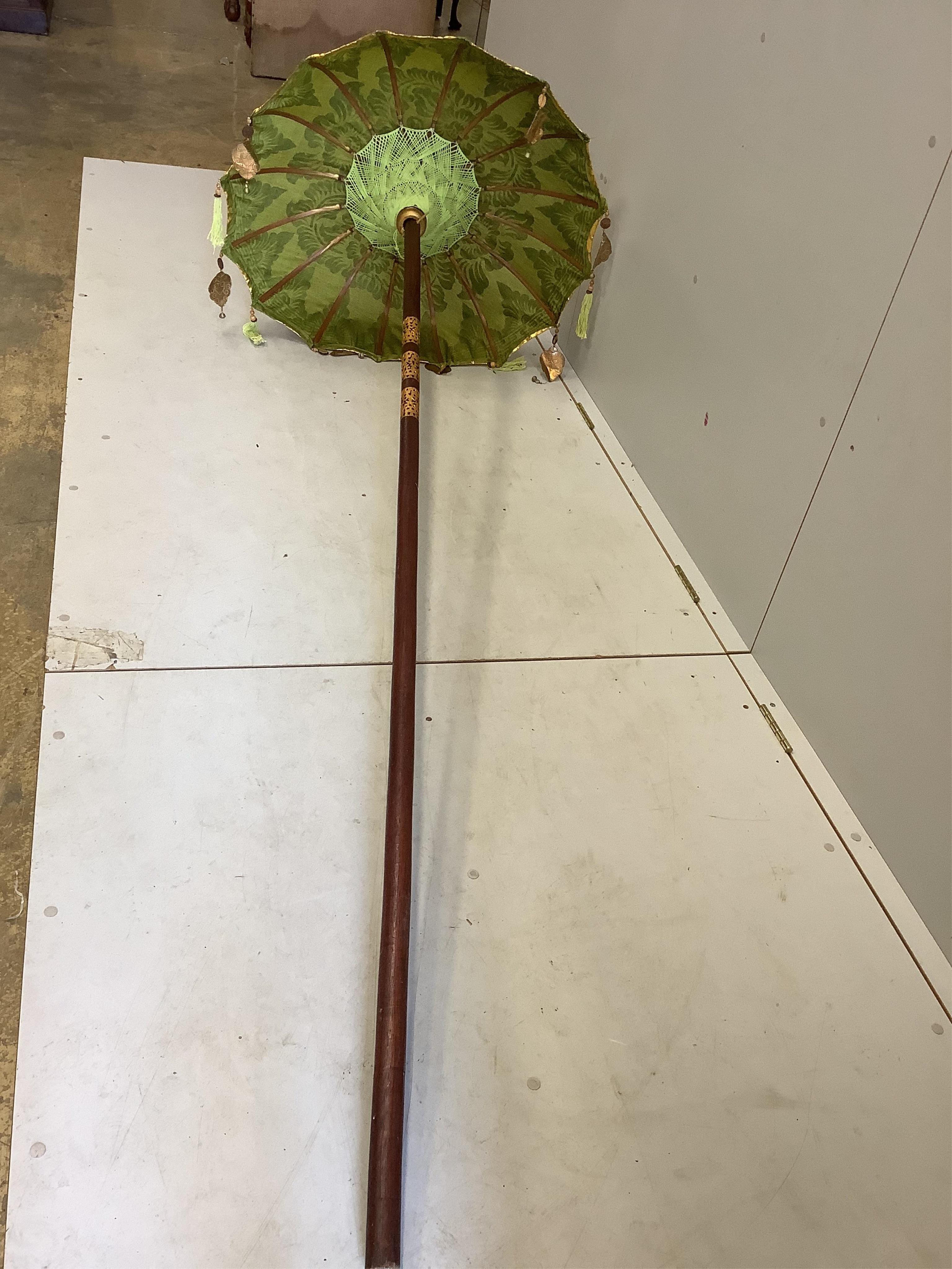 Two Indian parasols, larger approximately height 250cm. Condition - fair